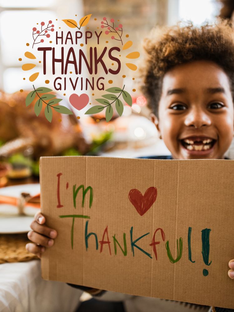 image shows a little boy with a thankful sign